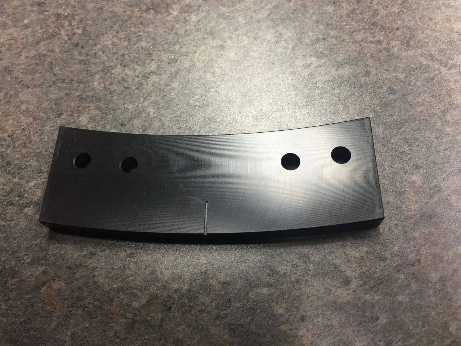 Curved black machined plate